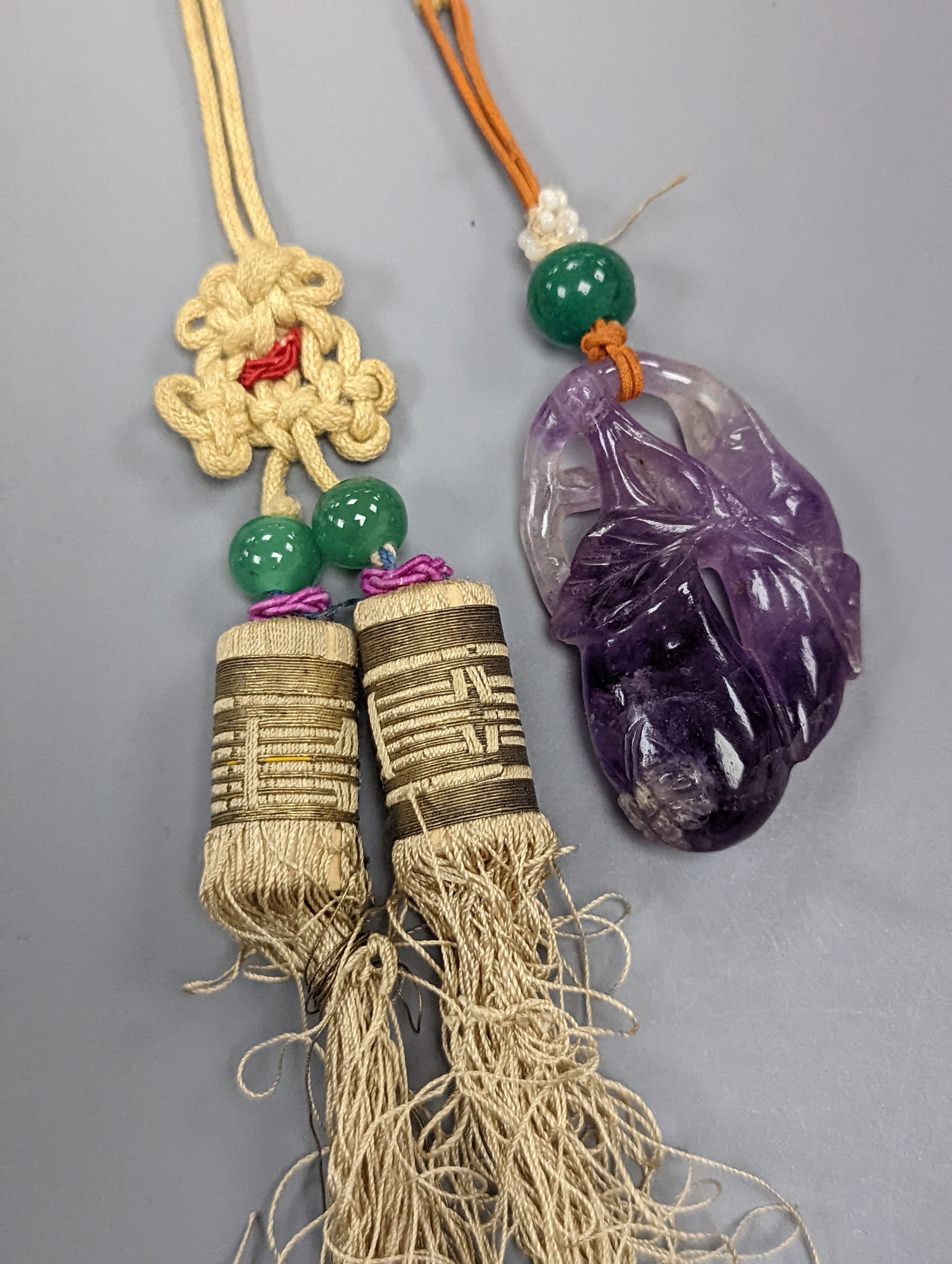 A 19th century Chinese carved amethyst pendant, 5cm on an ornate cord
